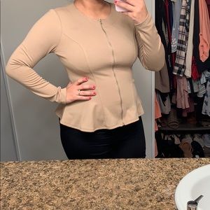 Nude long sleeve peplum top.